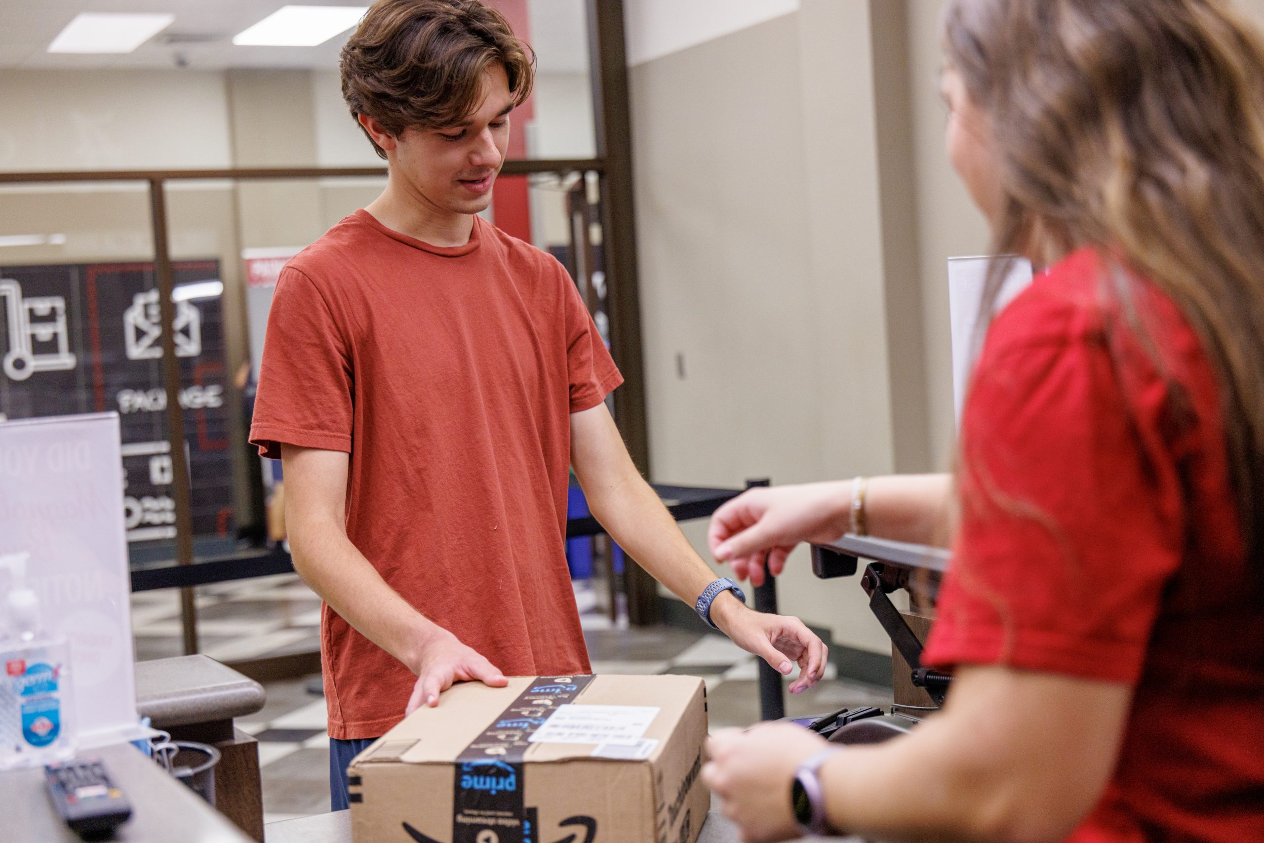 student picking up a package from the student mail center