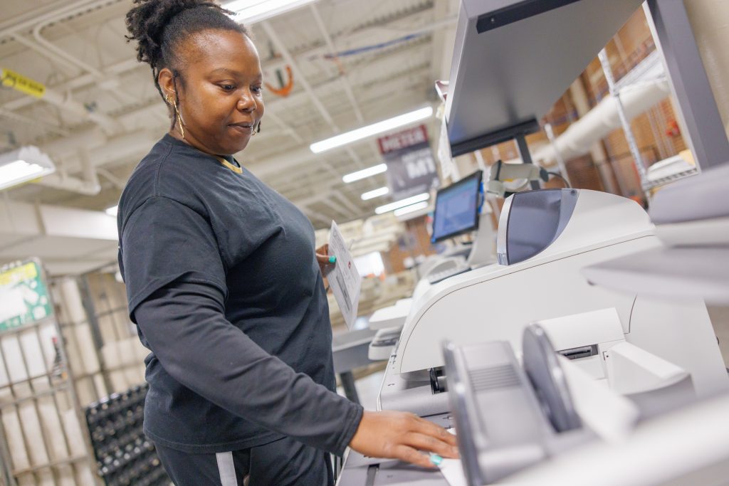 Campus Mail worker running letter mail through the meters