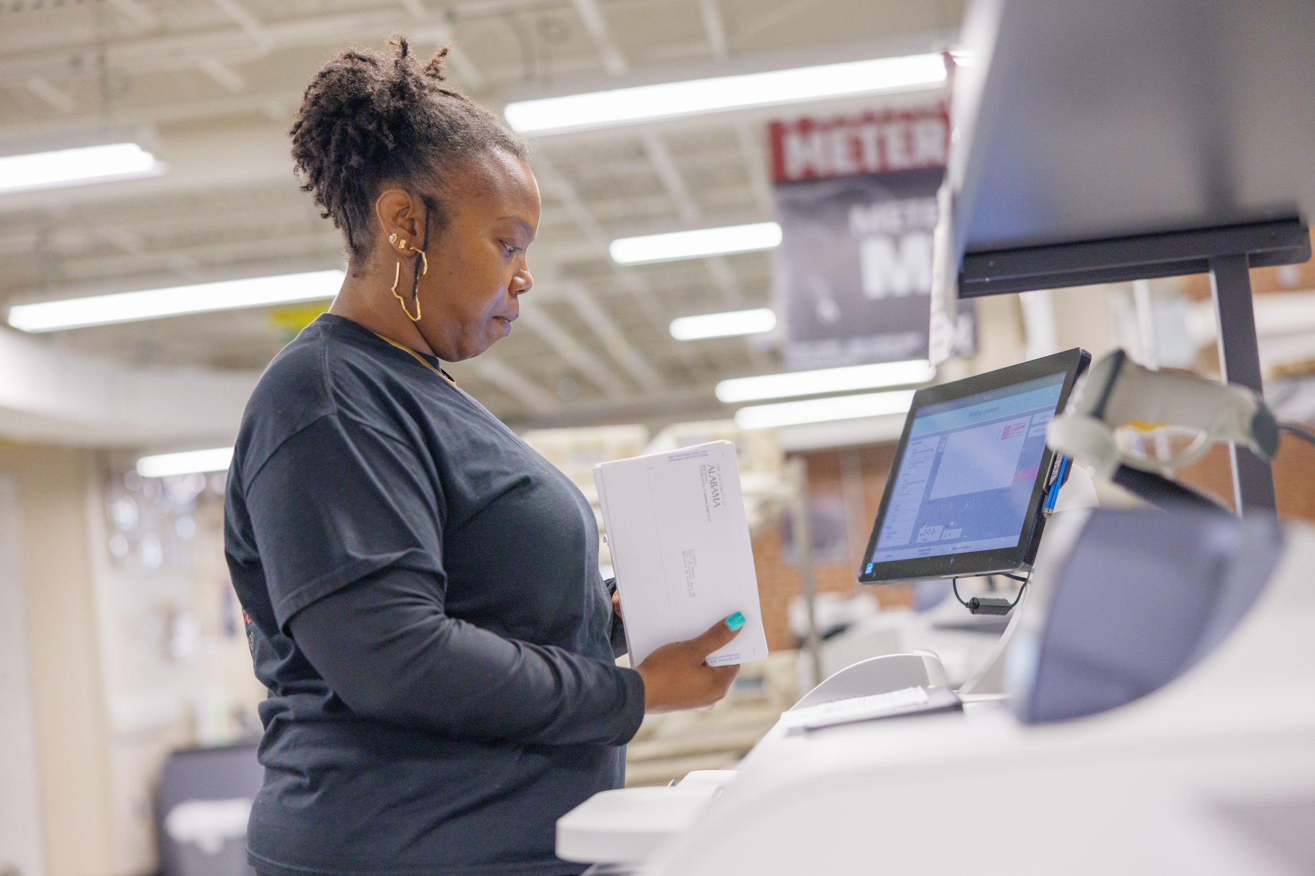 Campus Mail worker running mail through the meters.
