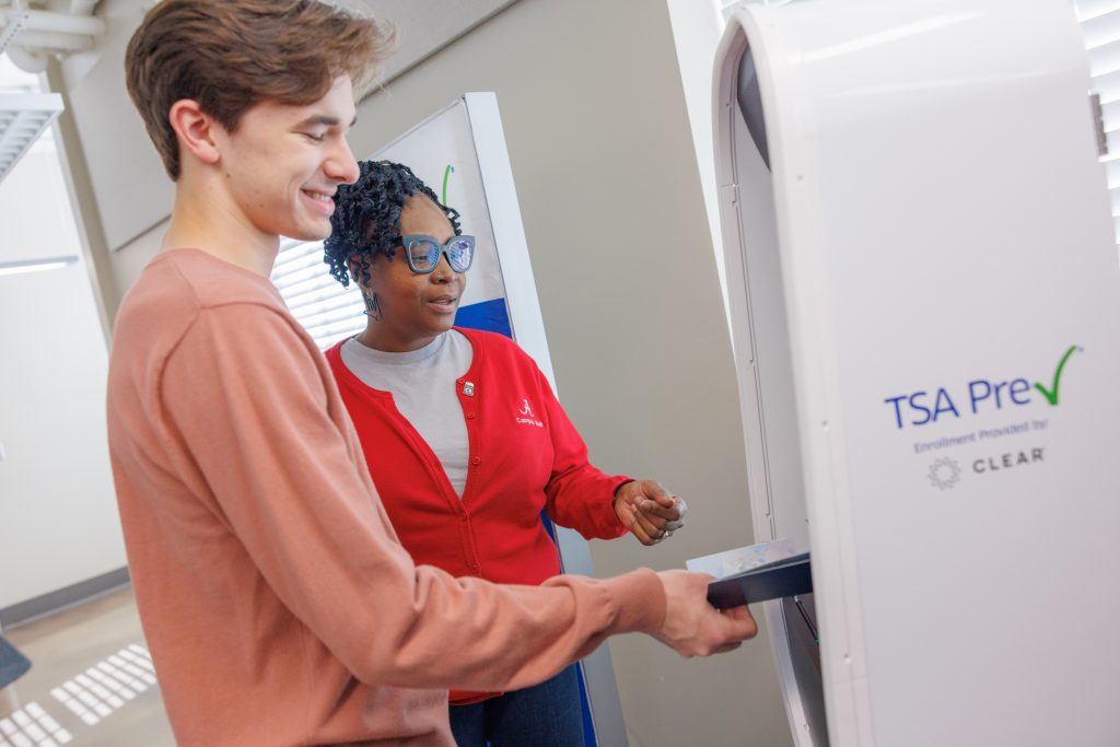 TSA agent helping a customer sign up for TSA PreCheck