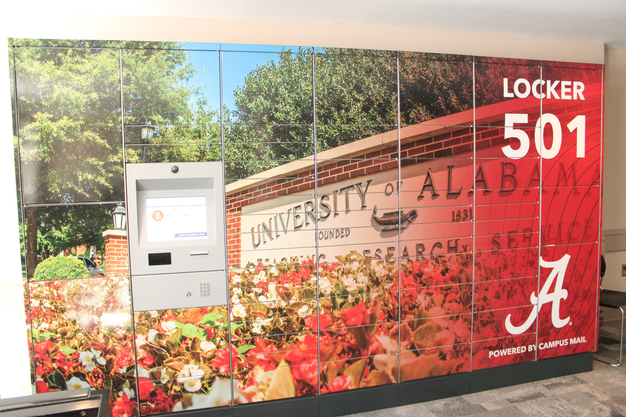 Locker 501 wrap of a University of Alabama sign with flowers in front.
